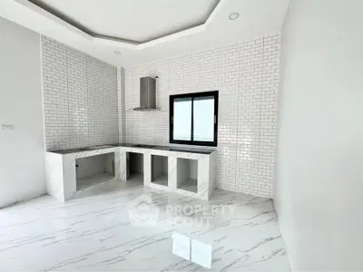 Modern kitchen with marble countertops and white subway tiles
