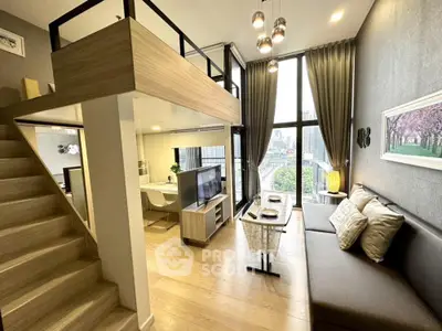 Modern loft apartment with high ceilings and large windows offering city views.