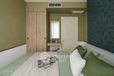 Modern bedroom with stylish decor and cozy bedding in a contemporary apartment.