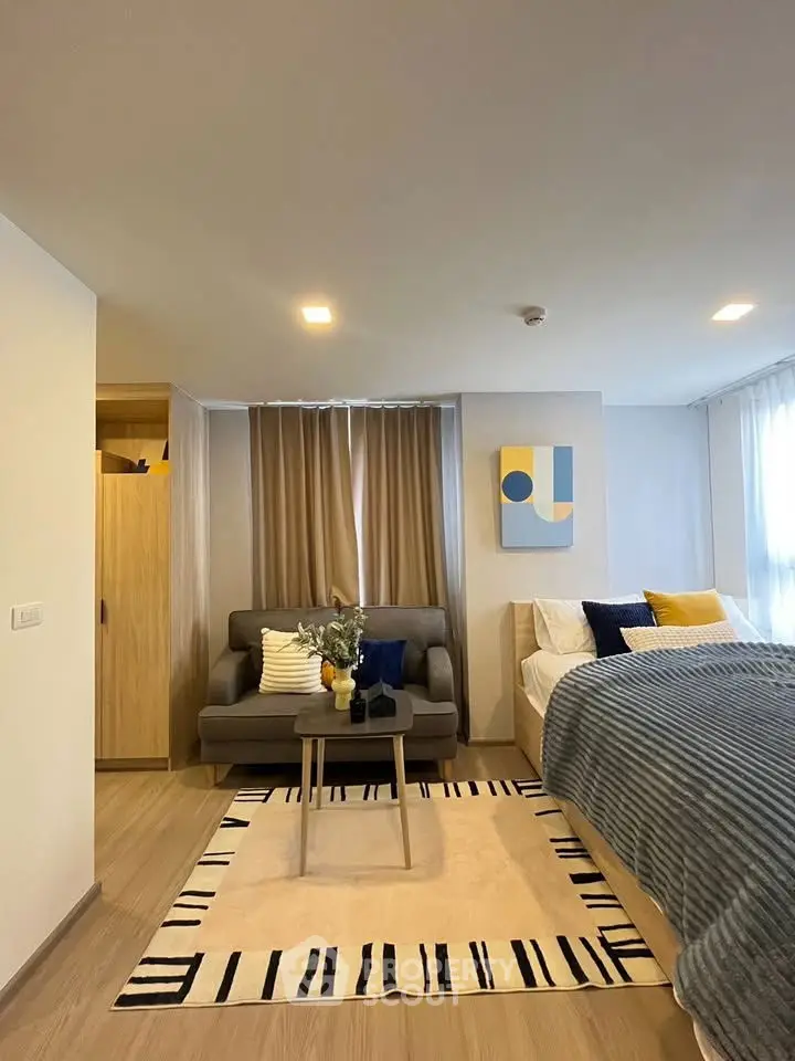 Modern studio apartment with cozy living area and stylish decor