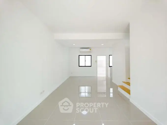 Spacious modern living room with glossy tiled floors and minimalist design