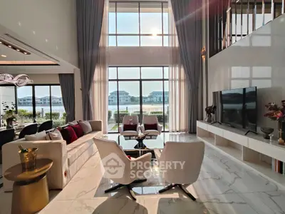 Luxurious living room with high ceilings and stunning waterfront view