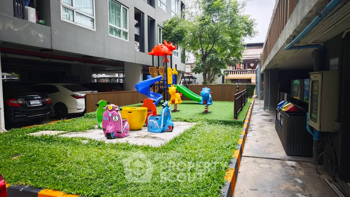 Charming residential playground with colorful equipment in a modern apartment complex.