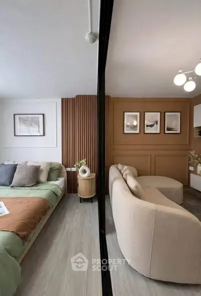 Modern open-layout living room and bedroom with stylish decor and cozy ambiance.