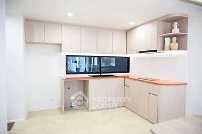 Modern kitchen with sleek cabinetry and vibrant countertop in a stylish apartment.