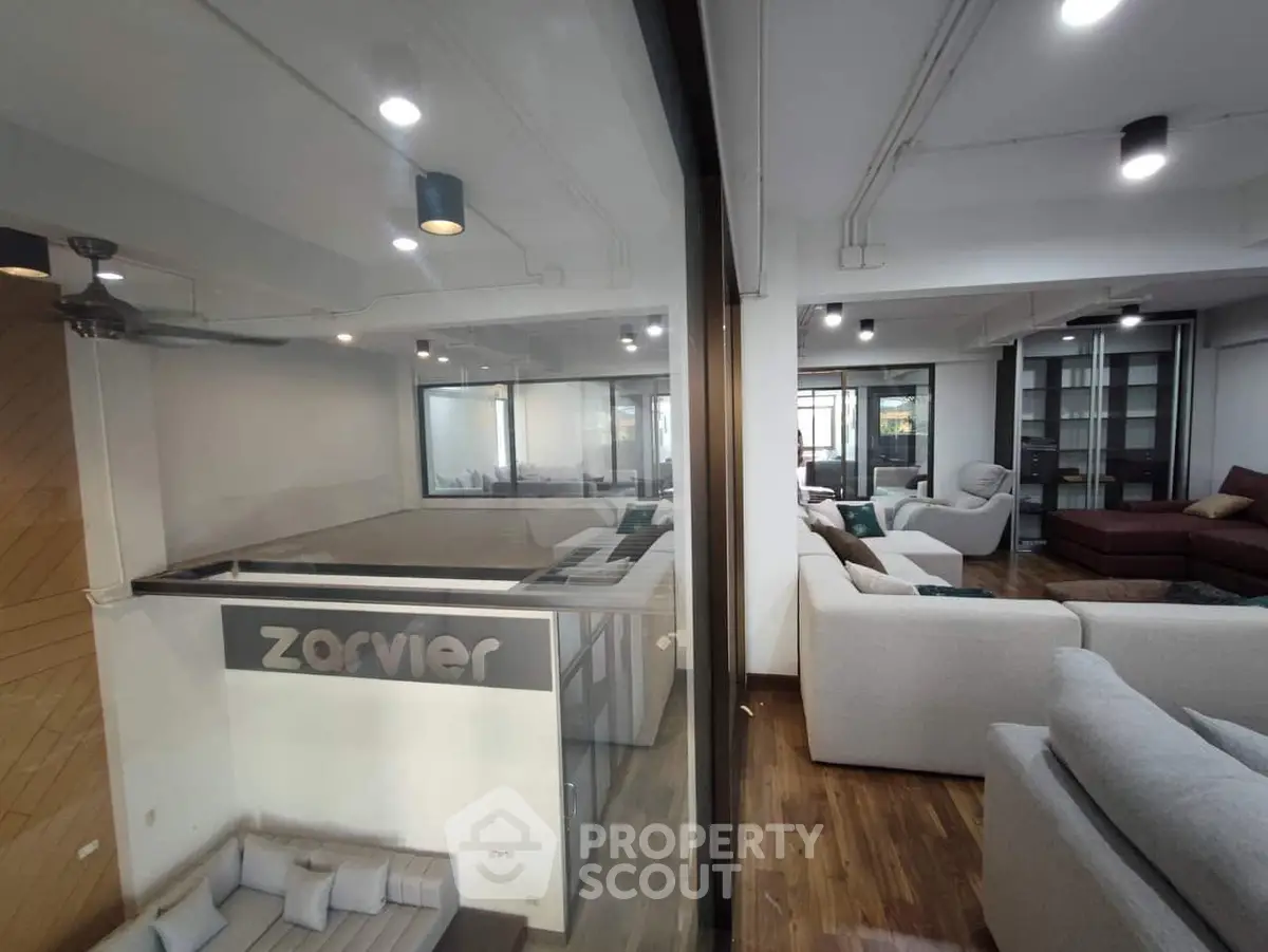 Spacious modern living room with elegant sofas and wooden flooring