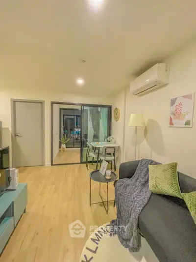 Modern living room with cozy decor and air conditioning in a stylish apartment.