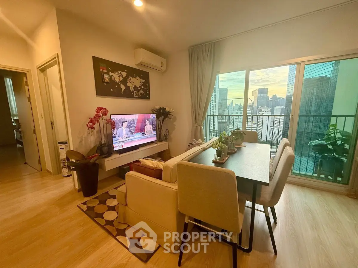 Modern living room with city view, stylish decor, and cozy seating area.