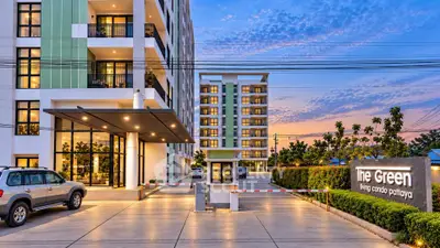 Modern condo building exterior with sunset view and entrance gate