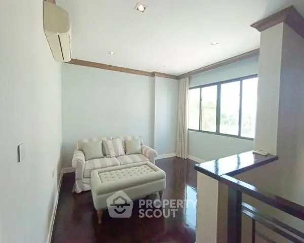 Charming living room with cozy sofa and natural light, perfect for relaxation.