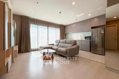 Spacious modern living room with open kitchen and large windows