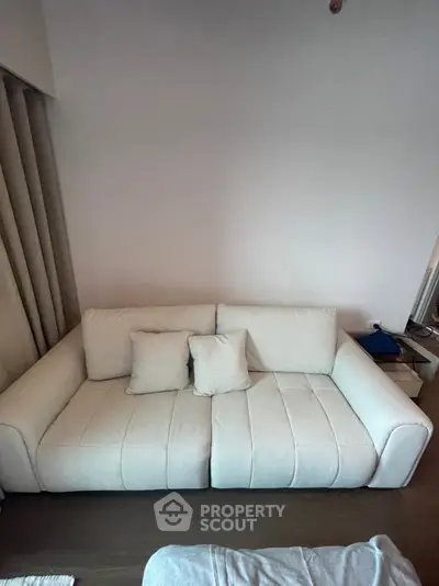Modern living room with stylish white sofa and minimalist decor