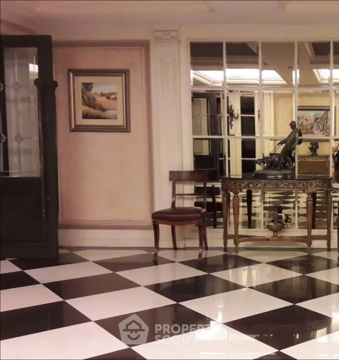 Elegant interior with checkered floor, ornate furniture, and decorative mirror in luxurious setting.