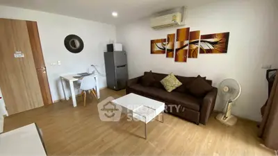 Modern living room with stylish decor, featuring a comfortable sofa, wall art, and a compact dining area.