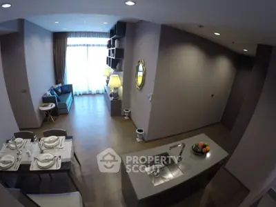 Spacious open-plan kitchen and dining area with modern appliances, leading to a cozy living room with ample natural light.