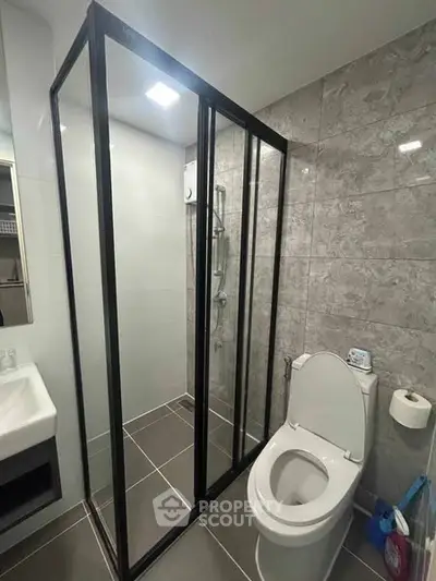 Modern bathroom with sleek shower enclosure and contemporary fixtures.