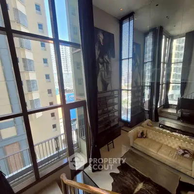 Luxurious high-rise living room with floor-to-ceiling windows and stunning city views.