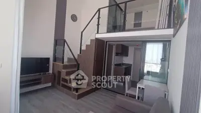 Modern duplex apartment with stylish interior, featuring a mezzanine, sleek kitchen, and cozy living area.