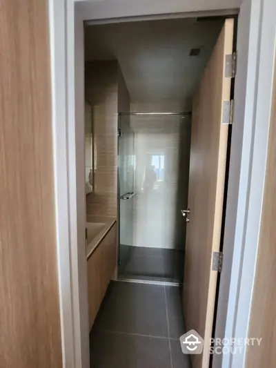 Modern bathroom with sleek glass shower and wooden accents