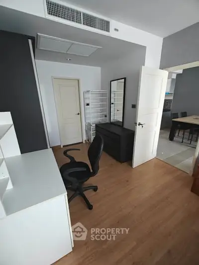 Modern study room with desk, chair, and storage in a stylish apartment
