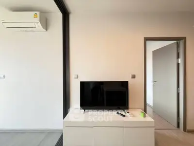 Modern living room with sleek TV setup and air conditioning