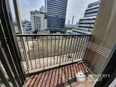 Modern urban balcony with city view and sleek railing design.