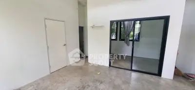 Spacious minimalist room with concrete floor and large window