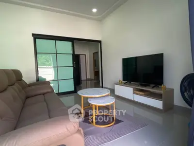 Modern living room with sleek furniture and large TV setup