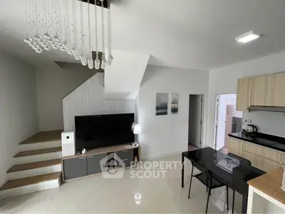 Modern living room with sleek staircase and open kitchen layout