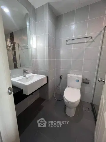 Modern bathroom with sleek gray tiles and contemporary fixtures