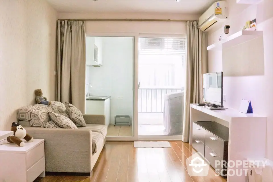 Cozy living room with modern decor and balcony access