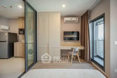 Modern studio apartment with open kitchen and balcony view