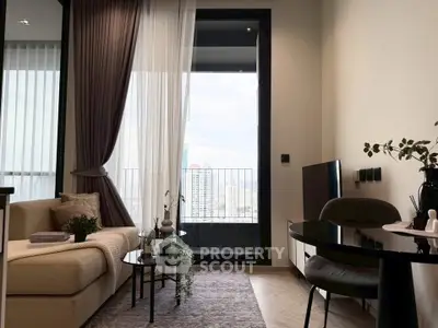 Modern living room with balcony view, elegant decor, and cozy seating area.