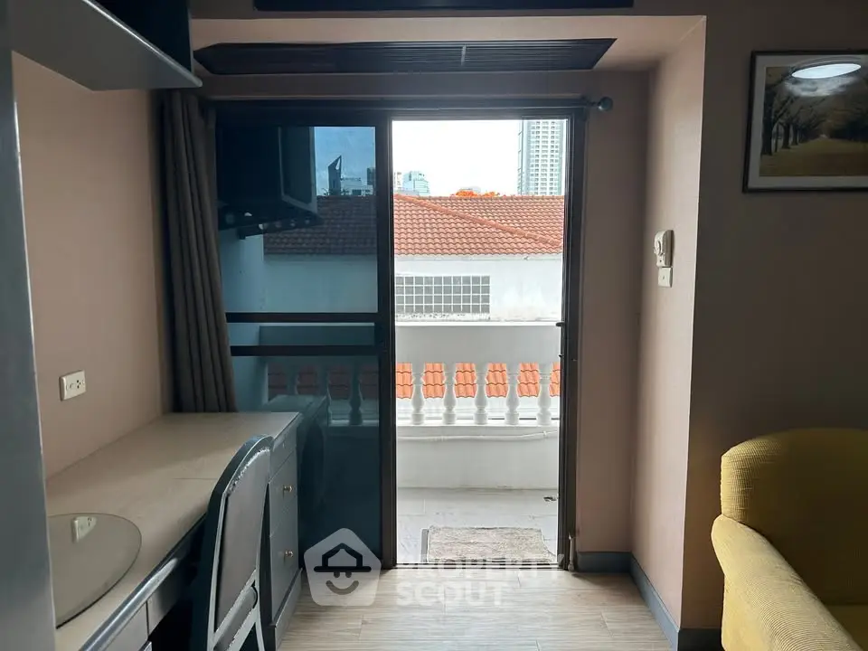 Cozy apartment with balcony and city view, featuring modern interior design and ample natural light.