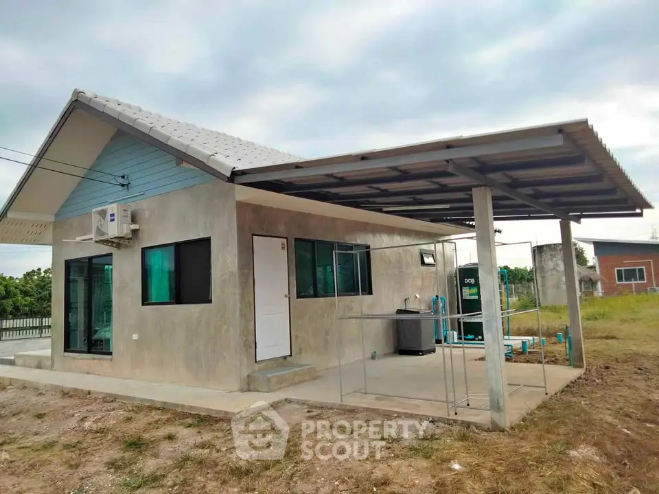 Modern single-story house with covered patio and air conditioning unit.