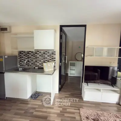 Modern compact kitchen with open layout and stylish living area