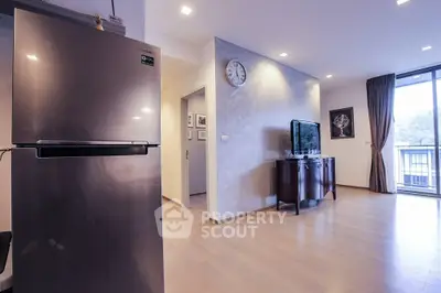 Modern living room with sleek fridge and balcony view