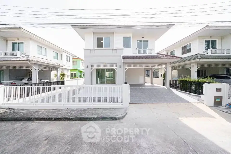 Modern two-story house with spacious driveway and contemporary design in a suburban neighborhood.