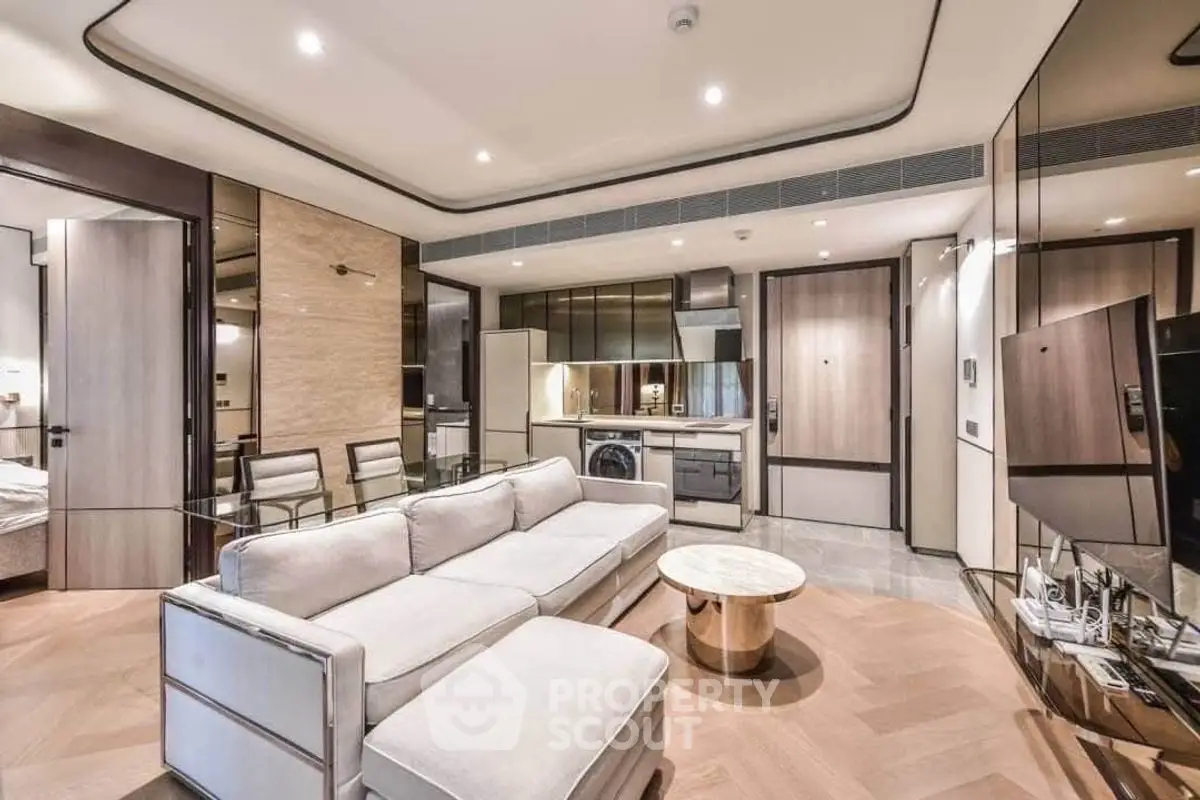 Luxurious modern living room with open kitchen, featuring sleek design and high-end appliances.