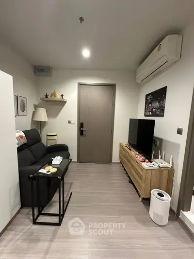 Cozy modern living room with sleek furniture and air conditioning