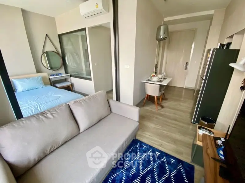 Modern studio apartment with cozy living area and stylish decor