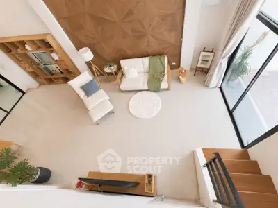 Spacious modern living room with stylish decor and large windows offering natural light.