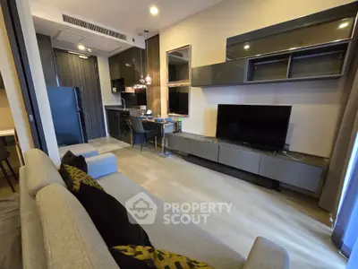 Modern living room with sleek furniture and open kitchen layout, perfect for contemporary urban living.