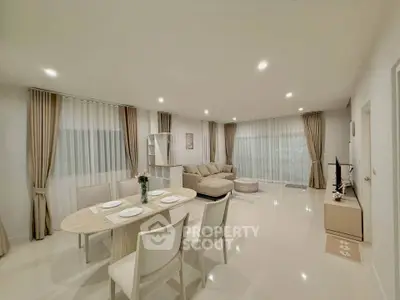 Spacious modern living room with elegant dining area and cozy seating.