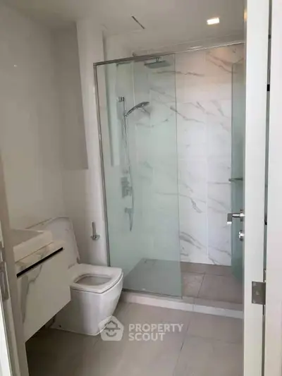 Modern bathroom with glass shower and sleek fixtures