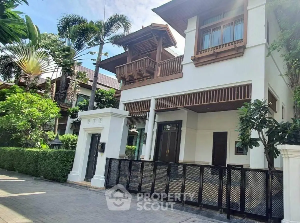Luxurious tropical villa with lush garden and elegant architecture for sale.
