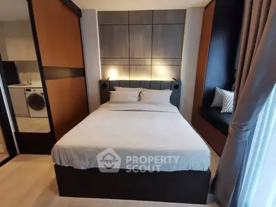 Modern bedroom with stylish decor and built-in seating area, featuring a cozy bed and sleek design elements.