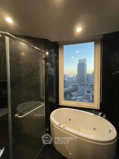 Luxurious bathroom with city view and modern bathtub in high-rise apartment.