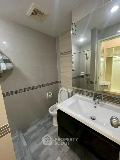 Modern bathroom with sleek fixtures and stylish tile design, perfect for contemporary living.