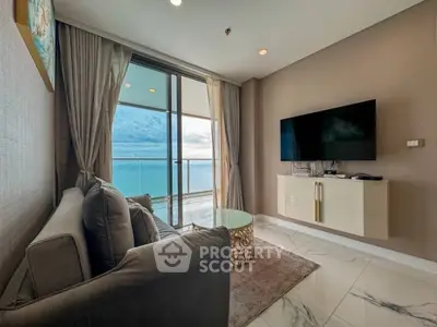 Luxurious living room with ocean view, modern decor, and sleek furnishings.